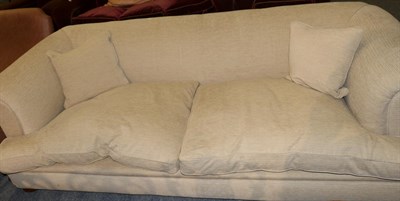 Lot 1184 - A cream Chesterfield style sofa