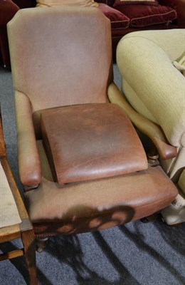 Lot 1196 - An oak framed leather easy chair together with matching footstool