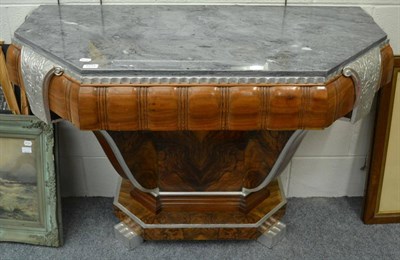 Lot 1215 - An Art Deco walnut and silvered console table, with a grey marble top, above a silvered frieze,...