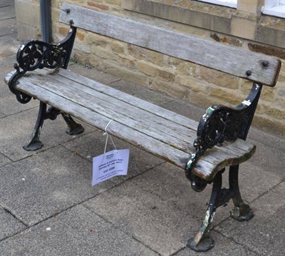 Lot 1226 - A Victorian slatted wooden garden bench with cast iron ends