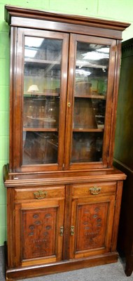 Lot 1240 - A glass fronted bookcase