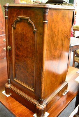 Lot 1263 - A 19th century walnut bedside cupboard with brass gallery