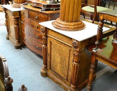 Lot 1269 - A pair of marble topped, burr walnut cabinets, one fitted with a cellaret, the other with...