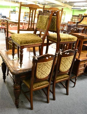 Lot 1281 - A Victorian carved oak wind out dining table and a set of six carved oak dining chairs