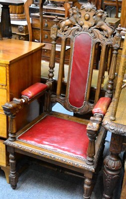 Lot 1284 - An impressive Victorian carved oak open armchair with studded leather slat seat and arms, and...