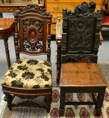 Lot 1289 - A carved mahogany hall chair together with a carved oak hall chair