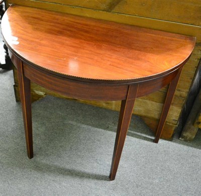 Lot 1293 - A George III line and checkered, string inlaid, demi lune foldover tea table