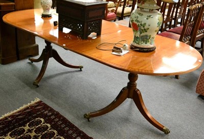 Lot 1295 - A pedestal dining table and additional leaf