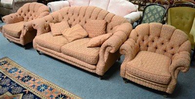 Lot 1310 - A buttoned hump back sofa with two matching armchairs (3)