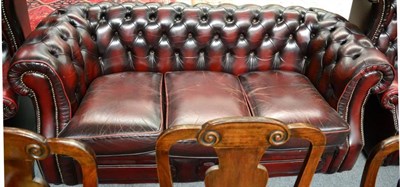 Lot 1319 - A Chesterfield style ox blood leather sofa