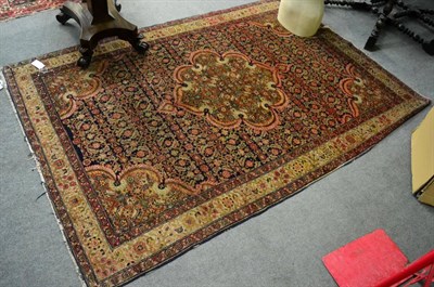 Lot 1327 - An Anatolian village rug with central medallion, red foliate pattern on dark blue ground, 212cm...