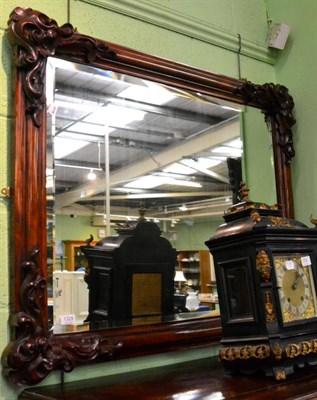 Lot 1329 - A carved mahogany mirror with rectangular bevelled plate