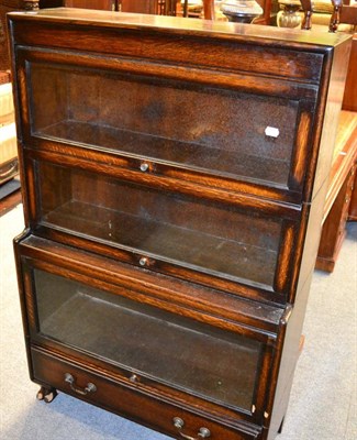 Lot 1341 - A 1920's oak three sectional bookcase