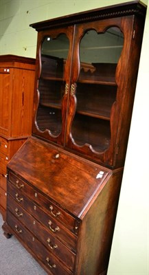 Lot 1357 - A George II mahogany bureau bookcase, 3rd quarter 18th century with a dentil cornice above...