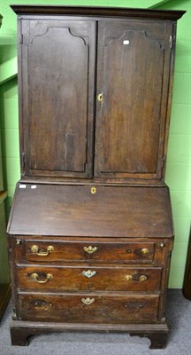 Lot 1358 - An 18th century oak bureau bookcase