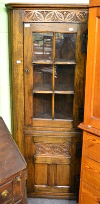 Lot 1360 - A reproduction oak standing corner cupboard