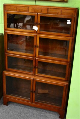 Lot 1364 - A four tier glazed sectional bookcase