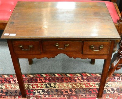 Lot 1373 - A George III oak lowboy, the front fitted with three short drawers, on square supports