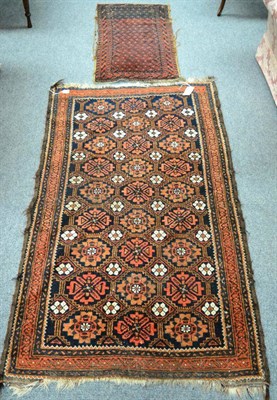 Lot 1384 - A Balouch rug. Persian/Afghan Frontier, the indigo honeycomb lattice field of stylised...