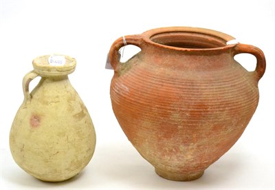 Lot 3 - A late Roman terracotta Amphora, circa 300-500 AD, of tapering ribbed form with twin handles,...