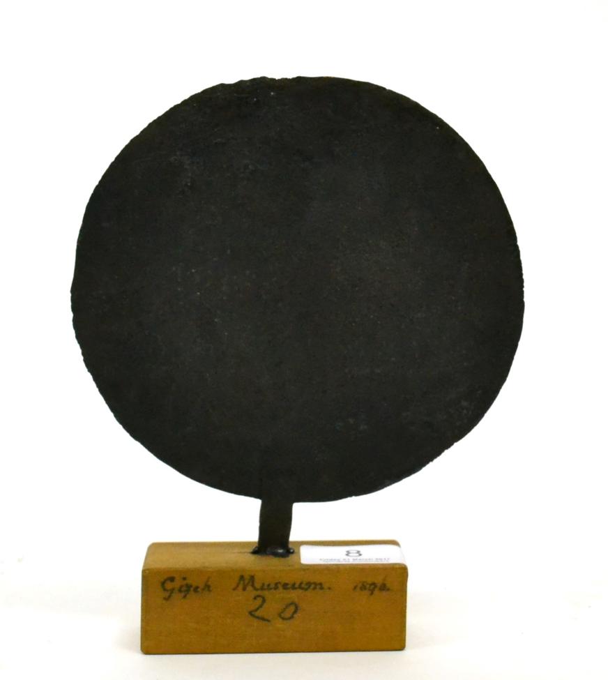Lot 8 - An ancient Egyptian middle kingdom bronze mirror, circa 1500-2000 BC, modelled as a standard,...