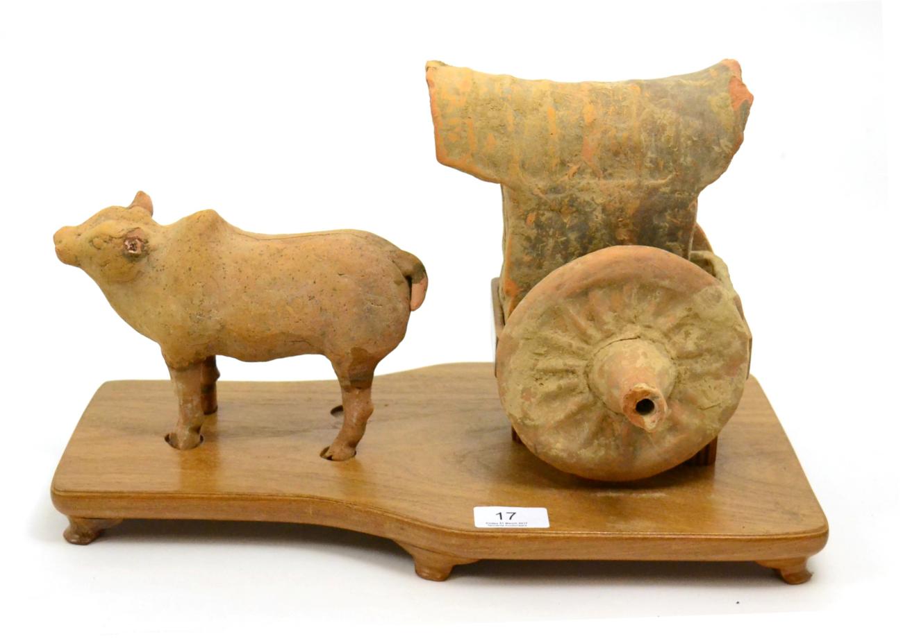 Lot 17 - A Chinese Tang Dynasty  pottery statue of an ox and cart, circa 618-907 A.D, modelled in the...