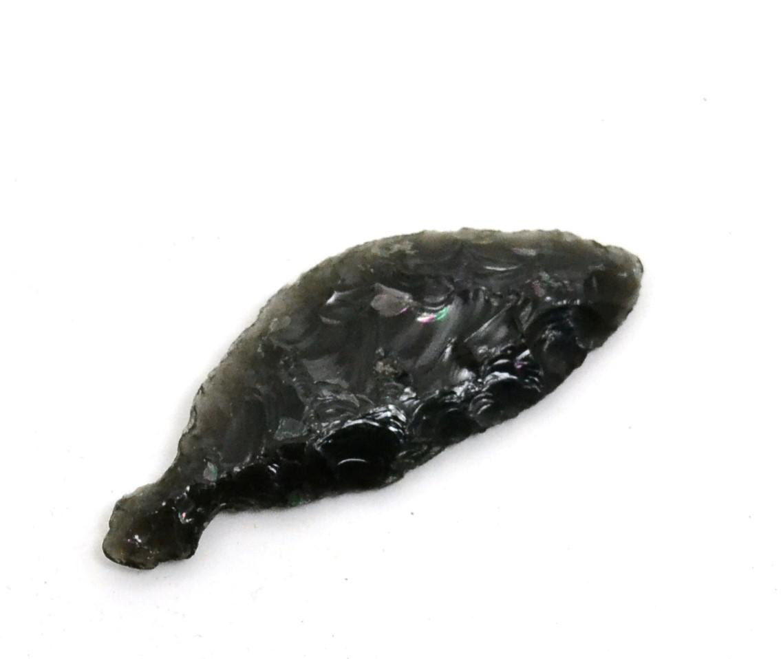 Lot 30 - A Japanese Jomon carved obsidian knife blade, of typical ancient workmanship and with mineral...