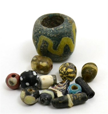 Lot 32 - A collection of Egyptian core-formed glass beads, Ptolemaic -Roman period, 4th century BCE-4th...