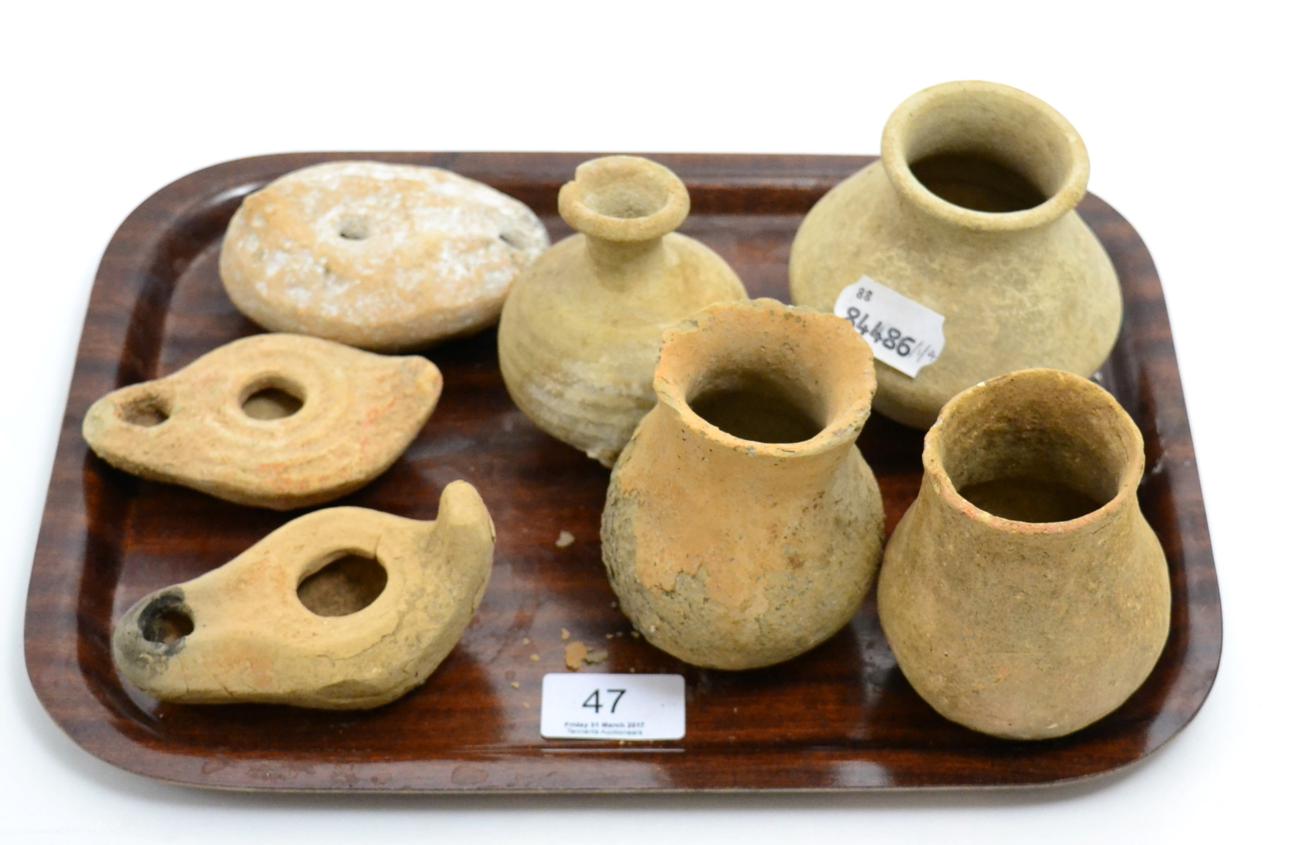 Lot 47 - Four Roman terracotta vases, circa 100-200 AD,  tallest 9cm high, three Roman terracotta oil lamps