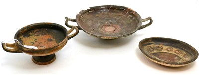 Lot 49 - An ancient Greek Athenian blackware tazze/ wine cup, circa 400-600 BCE, 2 slender pierced...