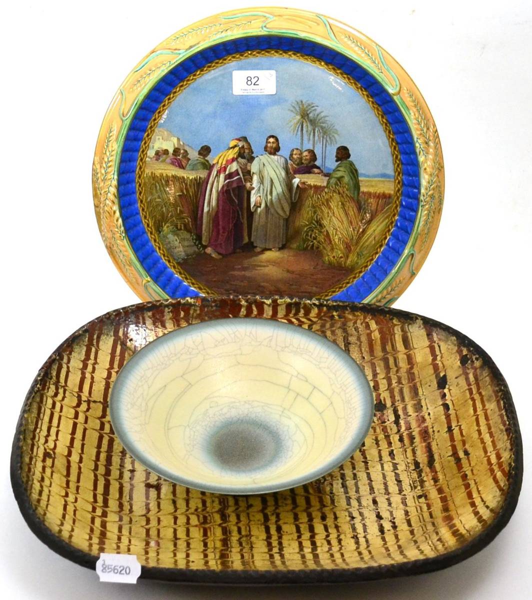 Lot 82 - A Victorian majolica bread plate, a 19th century slipware baking dish and a studio pottery bowl