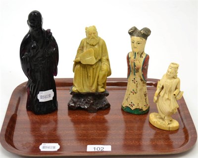 Lot 102 - A 19th century carved South East Asian ivory figure of a monk; a Chinese pottery figure of a...