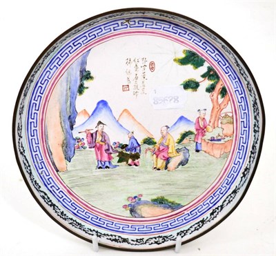 Lot 104 - A circular Chinese Canton enamel dish depicting of sage and acolytes in a mountain setting,...