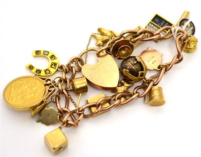 Lot 167 - A predominately 9ct gold charm bracelet with seventeen various charms, including a diamond set...