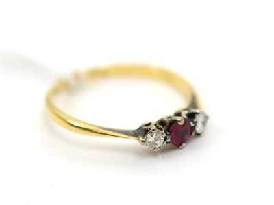 Lot 180 - A ruby and diamond three stone ring, finger size N1/2