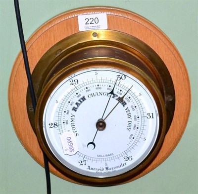 Lot 220 - An oak mounted aneroid barometer