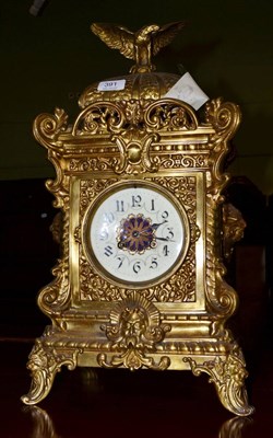 Lot 391 - An imposing striking gilt mantel clock decorated with scrolls, shells and caryatids surmounted...