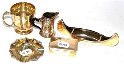 Lot 404 - Silverwares comprising a Christening mug, small jug, lidded box, ashtray and a canoe dish