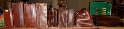 Lot 424 - Seven suitcases and Gladstone bags, a part canteen of silver plated flatware, an Eastern bronze...