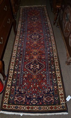 Lot 526 - A narrow Bidjar style runner, India, the terracotta field with three stepped medallions enclosed by