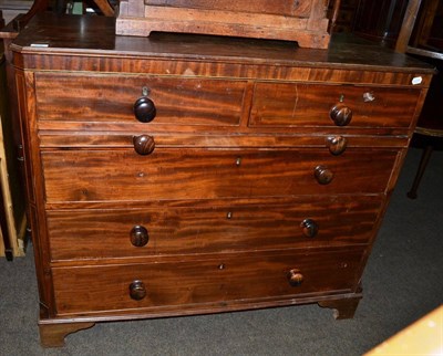 Lot 552 - A mahogany four height chest of drawers fitted with a dressing slide