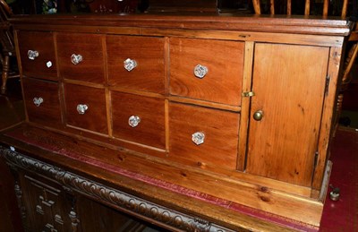 Lot 556 - A chemists' table top cabinet fitted with eight drawers and a cupboard, with glass handles and...