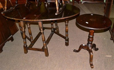 Lot 558 - An oak gate leg dining table and a modern circular top tripod table