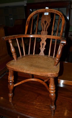 Lot 563 - A 19th century child's elm Windsor armchair with crinoline stretcher