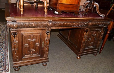 Lot 567 - A late Victorian carved oak leather inset pedestal desk