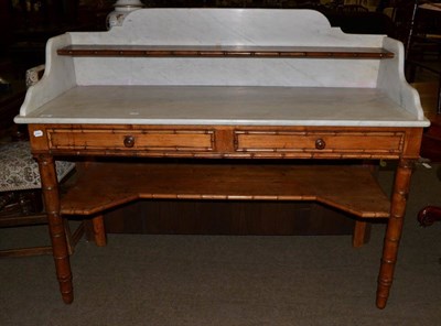 Lot 569 - A 19th century French faux bamboo marble topped washstand with pot shelf stretcher