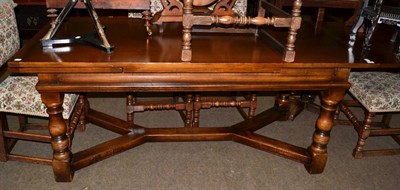 Lot 573 - An 18th century style oak draw leaf dining table