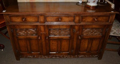 Lot 576 - An 18th century style panelled oak sideboard