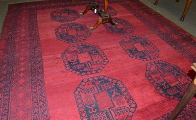 Lot 579 - A Turkmen Carpet, North Afghanistan, the abrashed crimson field with two columns of 'elephant foot'