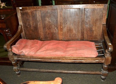 Lot 591 - An 18th century oak four panelled settle